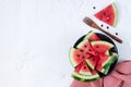 Sliced fresh watermelon in black bowl top view on white background Royalty Free Stock Photo