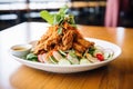 sliced fried chicken atop a fresh salad