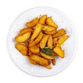 Sliced fried potatoes, Creole-style with spices. On a white plate