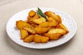 Sliced fried potatoes, Creole-style with spices. On a white plate