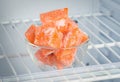 Sliced frozen pumpkin in the freezer in a glass piala