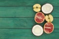 Sliced fruit - grapefruit, coconut, apple, on a wooden background. Royalty Free Stock Photo