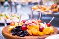 Sliced fruit on the plate,sliced fruit, grapes, dried fruit, cheese, banquet table, catering, celebration, new year, christmas,foo Royalty Free Stock Photo