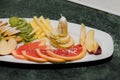 Sliced fruit on a white plate, grapes, kiwi, orange, pear Royalty Free Stock Photo