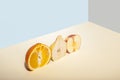 sliced fruits: orange, apple, pear. Exposed in a cut line, on a gray-blue background. Summer minimalism Royalty Free Stock Photo