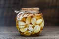 Sliced garlic cloves in honey in glass jar, closeup. Honey infused garlic