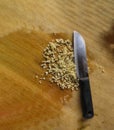 Sliced garlic cloves on wooden chopping Board