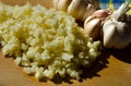 Sliced garlic on a wooden cutting board in a home kitchen