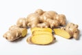 Sliced ginger beside fresh root Royalty Free Stock Photo