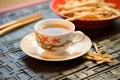 sliced ginseng root on saucer beside ginseng tea in mug Royalty Free Stock Photo