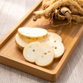 Sliced Ginseng Root with Wooden Tray in Bright Studio Lighting Still Life Royalty Free Stock Photo
