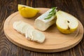 Sliced goats cheese rosemary and pear on wooden table Royalty Free Stock Photo