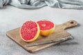 Sliced grapefruit on cutting board with knife Royalty Free Stock Photo