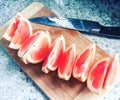 Sliced Grapefruit with Knife Royalty Free Stock Photo