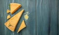 Sliced and grated parmesan cheese. set of hard pieces of parmesan cheese with knifes on a wooden background. Long banner format.