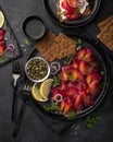 Sliced Gravlax,  scandinavian beet cured salmon  served with red onion, capers,  lemon and crisp bread Royalty Free Stock Photo