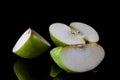 Sliced green apple on black from side Royalty Free Stock Photo