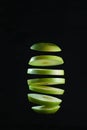 Sliced green apple levitates on black background Royalty Free Stock Photo