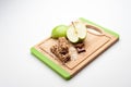 Sliced green apples with candies on the wooden board