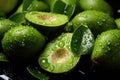 Sliced green avocados with glistening water droplets on dark background Royalty Free Stock Photo