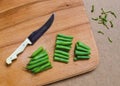 Sliced green beans on the table with a knife Royalty Free Stock Photo