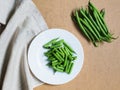 Sliced green beans on a white plate and a bunch of green beans Royalty Free Stock Photo