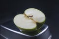 sliced green granny apple on a black background Royalty Free Stock Photo