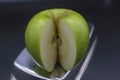 sliced green granny apple with a piece on a black background top view Royalty Free Stock Photo