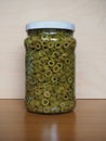 Sliced green olives in brine in glass jar Royalty Free Stock Photo