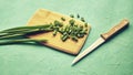 sliced green onions on a wooden chopping board next to a knife Royalty Free Stock Photo