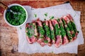 Sliced grilled barbecue beef steak with green chimichurri sauce