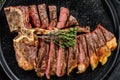 Sliced Grilled Florentine steak. T bone meat beef. Black background. Top view Royalty Free Stock Photo