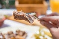 Sliced grilled lamb chops on a fork. Woman have a dinner in a greek tavern. Royalty Free Stock Photo