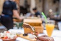 Sliced grilled lamb chops on a fork. Woman have a dinner in a greek tavern. Royalty Free Stock Photo