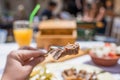 Sliced grilled lamb chops on a fork. Woman have a dinner in a greek tavern. Royalty Free Stock Photo