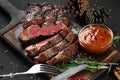 Sliced grilled medium rare beef steak served on wooden board Barbecue, bbq meat beef tenderloin. Royalty Free Stock Photo