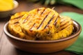 sliced grilled pineapple in a fruit bowl