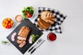 Sliced grilled roast beef with fork and knife on stone serving board. Royalty Free Stock Photo