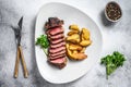 Sliced Grilled rump Beef steak with potato. White background. Top view