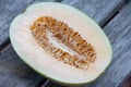 Sliced half Cantaloupe on wooden table background.