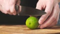 Sliced in half fresh lime with knife on wooden chopping board. Close up. Royalty Free Stock Photo