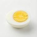 sliced half of a hard-boiled egg, centered, showing a smooth white and a bright yellow yolk Royalty Free Stock Photo