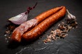 sliced half of smoked dry sausage with garlic and slice of onion Royalty Free Stock Photo