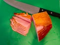 ADelicious looking sliced ham on a cutting board.