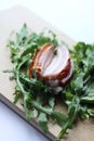 Sliced ham with fresh green lettuce leaves on a cutting board. Royalty Free Stock Photo