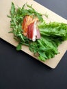Sliced ham with fresh green lettuce leaves on a cutting board. Royalty Free Stock Photo