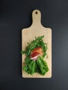 Sliced ham with fresh green lettuce leaves on a cutting board. Royalty Free Stock Photo