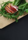 Sliced ham with fresh green lettuce leaves on a cutting board. Royalty Free Stock Photo