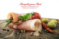 Sliced ham with rosemary, tomatoes and olives on a wooden table Royalty Free Stock Photo