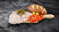 Sliced ham salami decorated on wooden board with olives, tomato Royalty Free Stock Photo